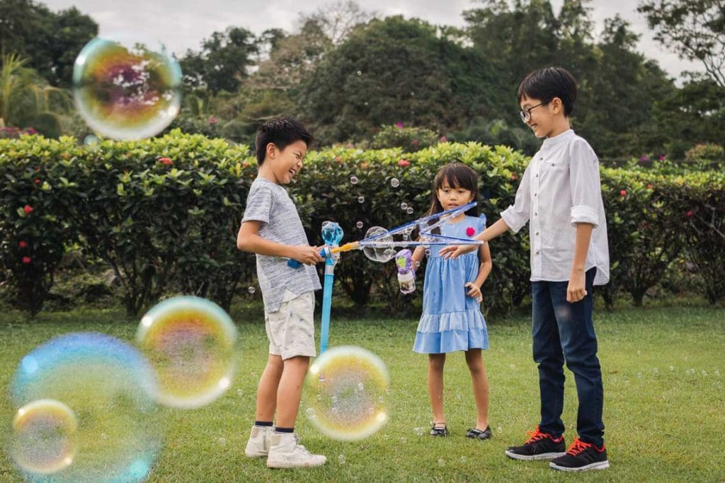 Family photography Singapore kids playing bubble