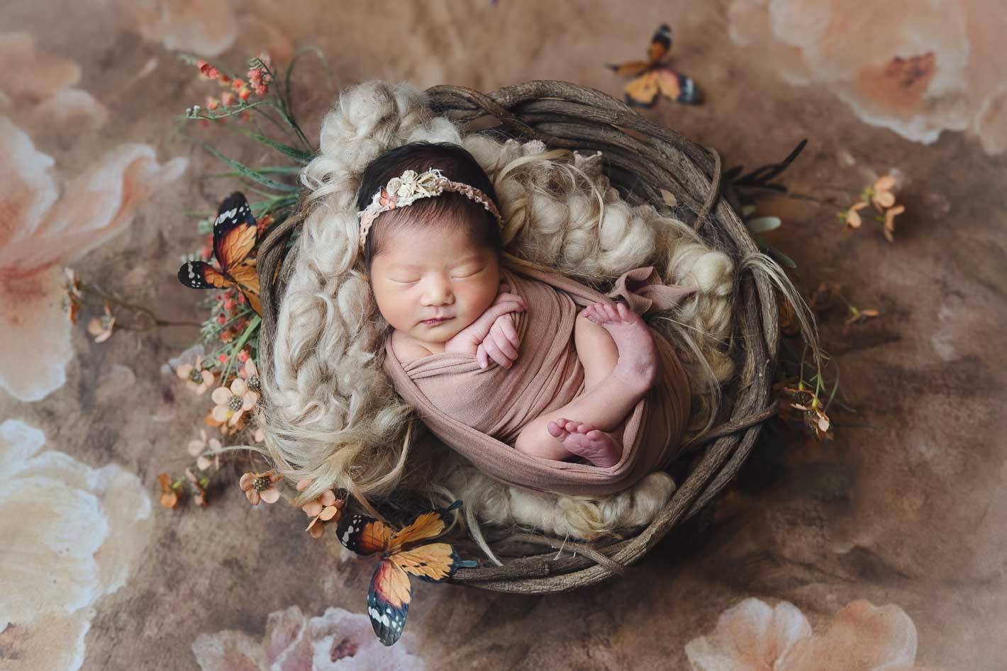 Dreamy newborn portrait with butterfly and floral styling, newborn photography Singapore