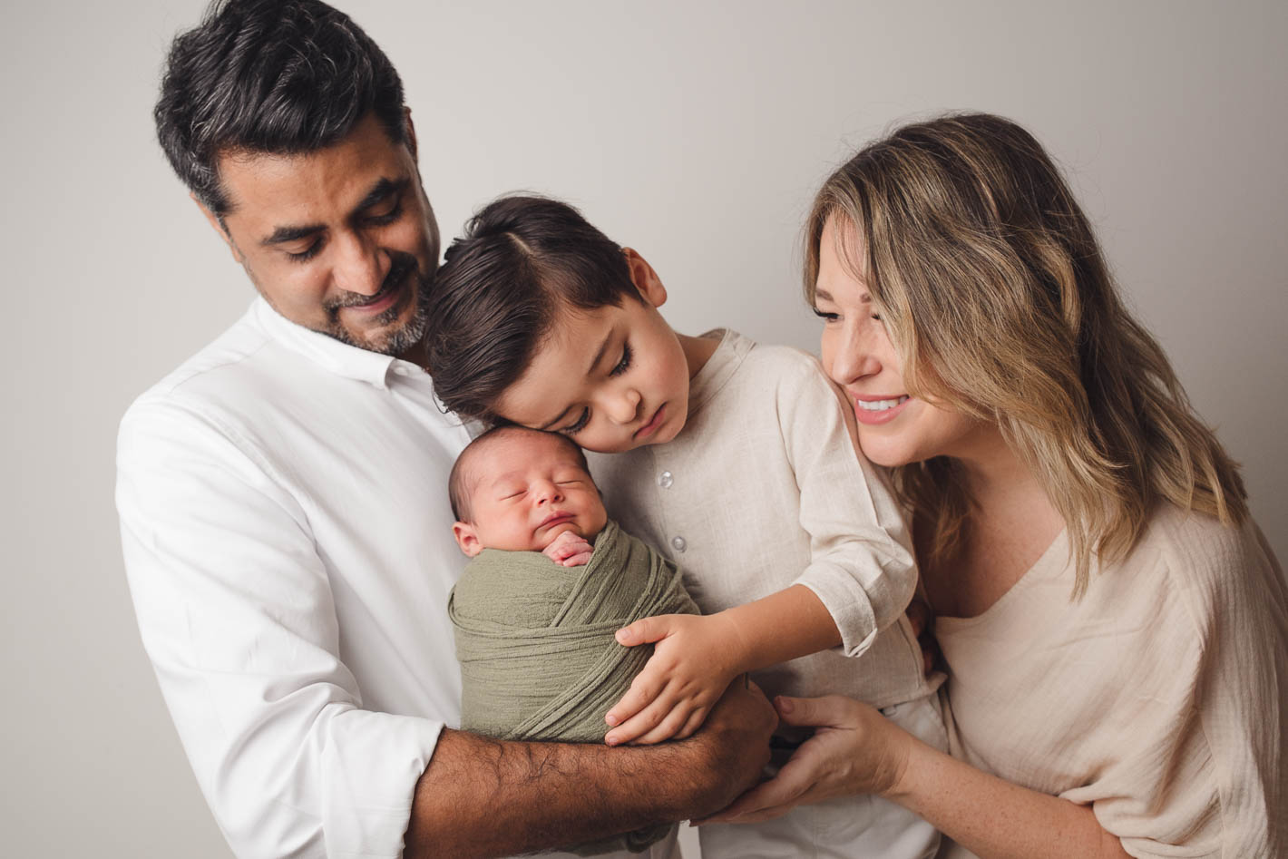 Candid family moment captured during a newborn photoshoot session in Singapore
