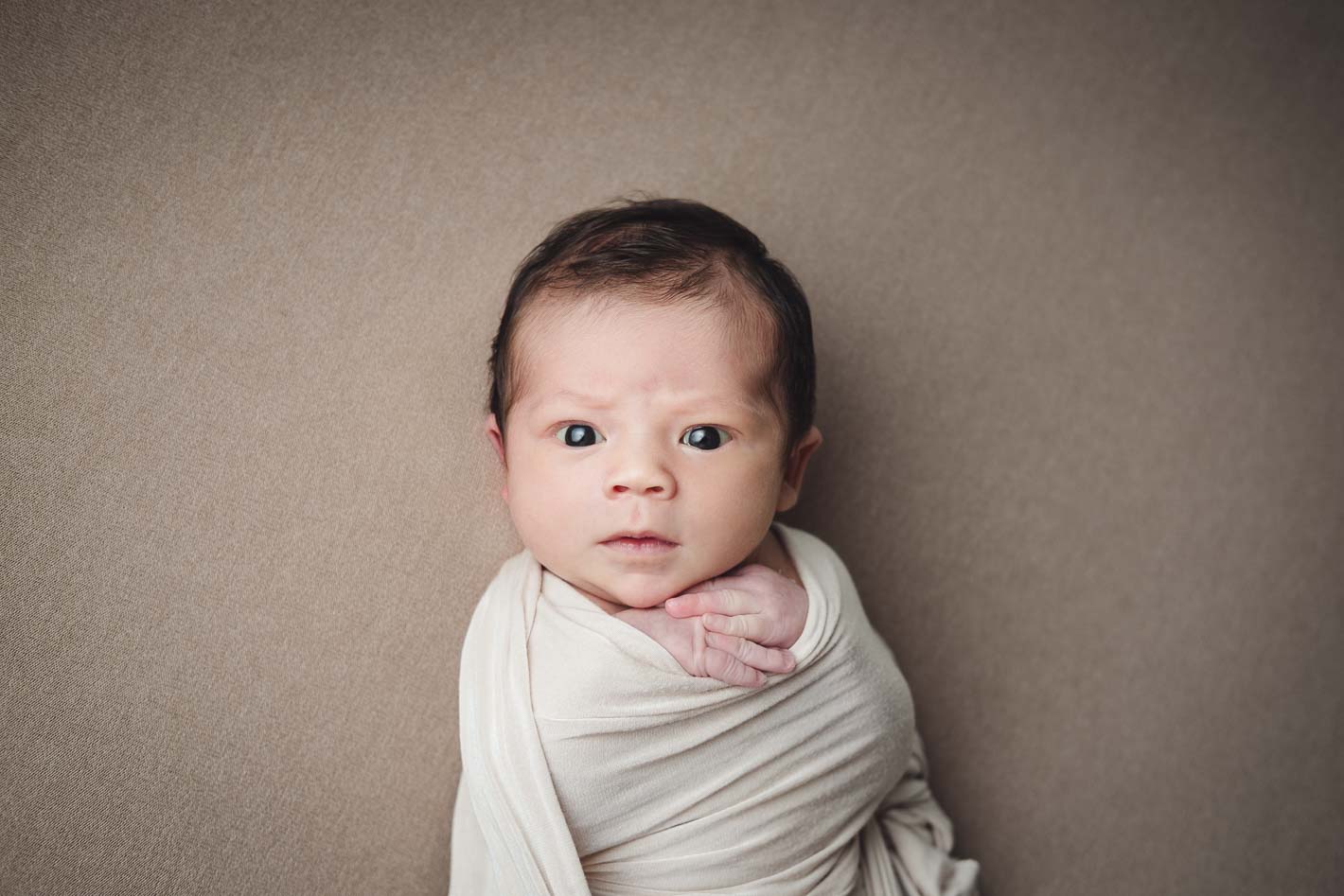 Stern baby face staring at photographer