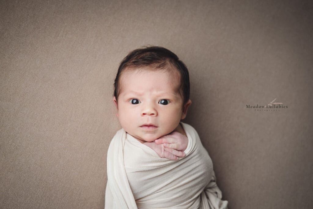 Newborn photography Singapore Stern baby face staring at photographer