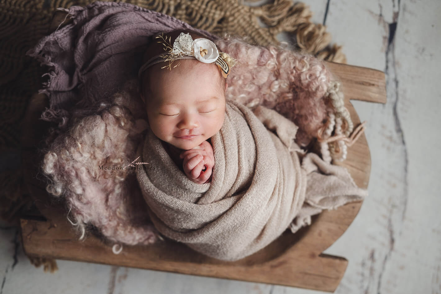 Newborn baby posed in a rustic hand-carved vintage dough bowl prop, newborn photography Singapore