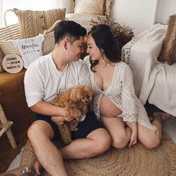 Pregnant mum posing with husband and dog