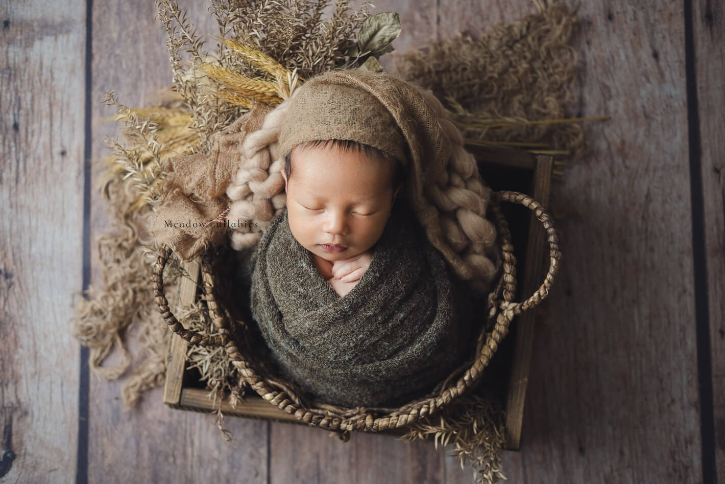 Singapore newborn photography newborn wrapped posing in wooden crate box