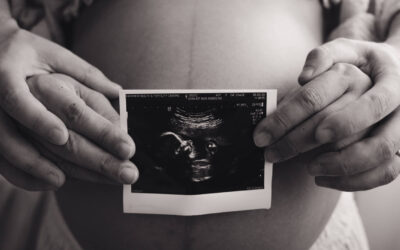 Maternity photography Singapore Maternity photoshoot - couple holding ultrasound film in front of tummy