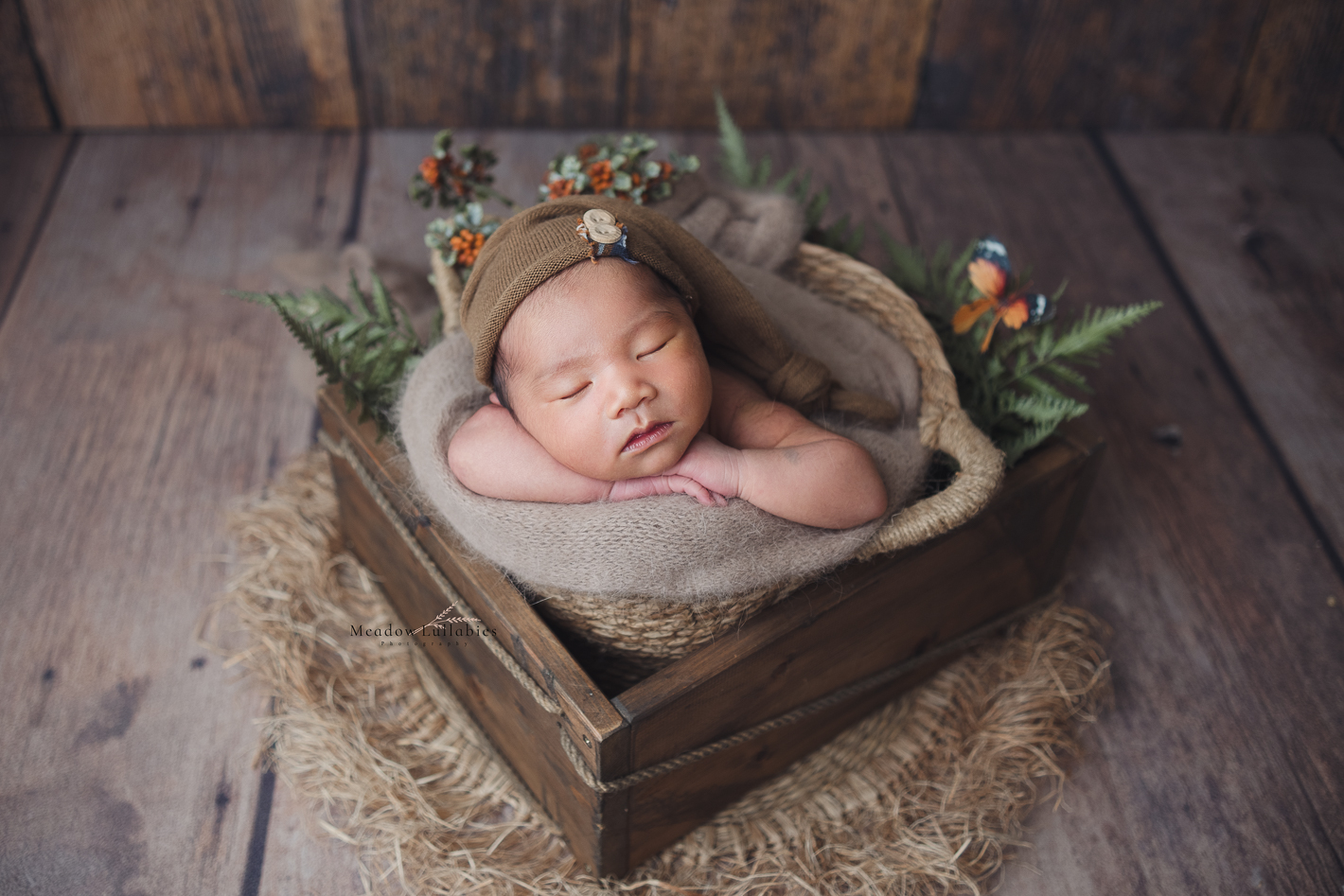 newborn baby boy posing in wooden crate prop